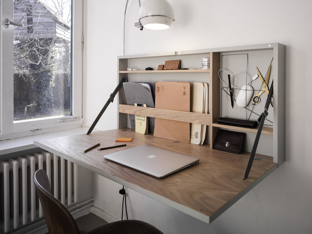 I like how this foldable wall desk has some storage options for notebooks, pencils etc so it can still feel personal. Photo via  Doris Götz